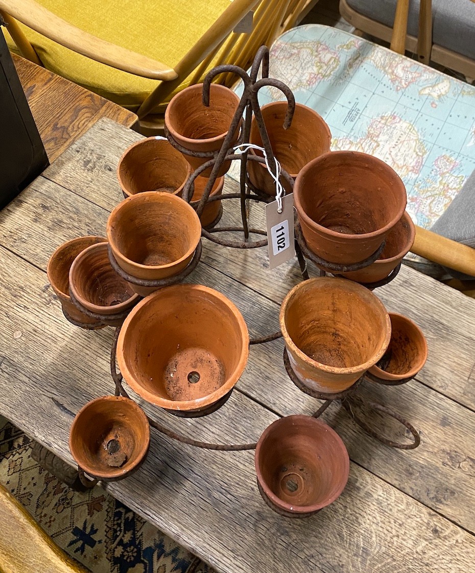 Fifteen small terracotta pots on wrought iron stand, height 52cm